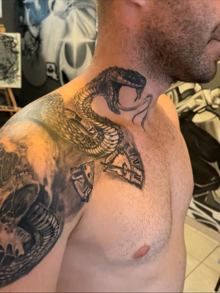 Black and grey cobra coiled up the side of the neck, with a broken hourglass on the collarbone