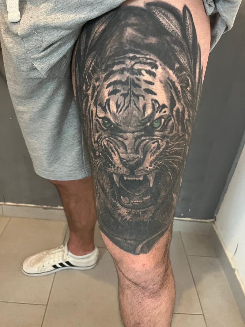 Photorealistic tiger head on a thigh, black and grey with green eyes