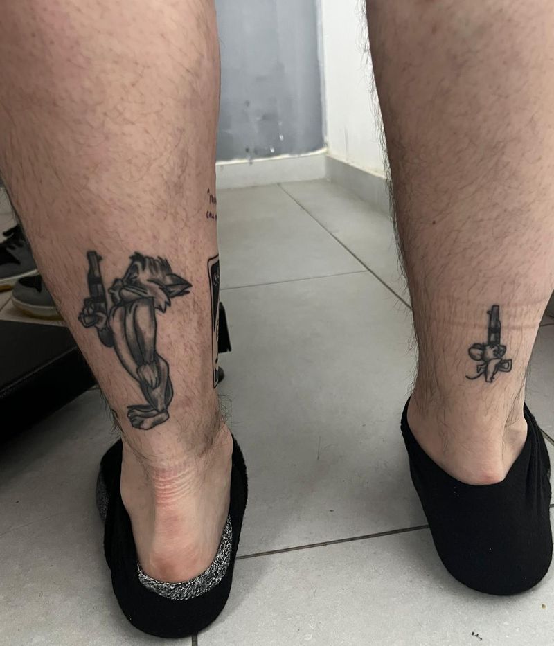 Matching Tom and Jerry pieces, one on each calf, both armed