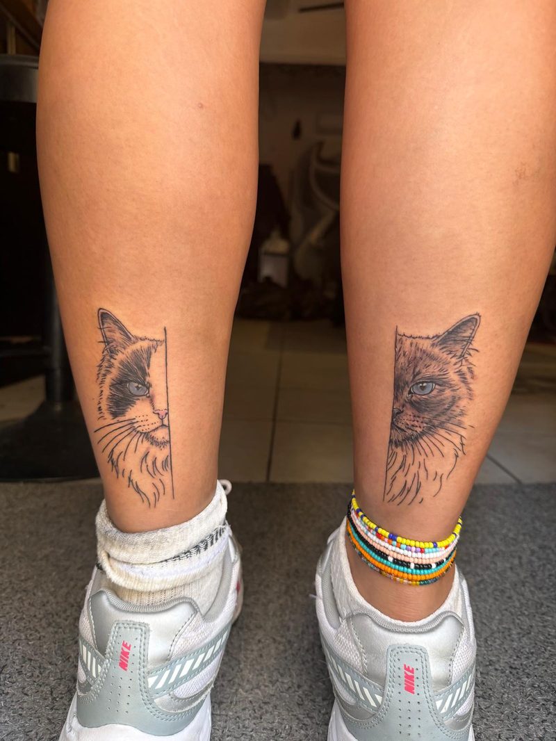 Matching half-portraits of a cat, one on each calf, fine line with realism faces, one with blue eyes